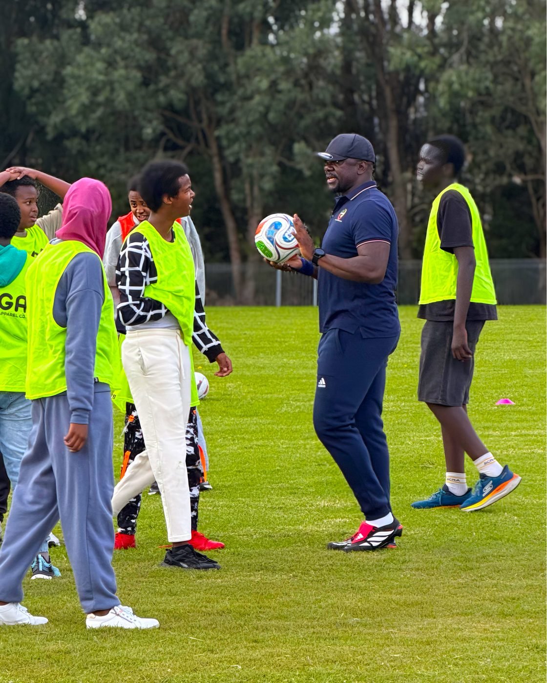 Coach talking with a group of players during a session
